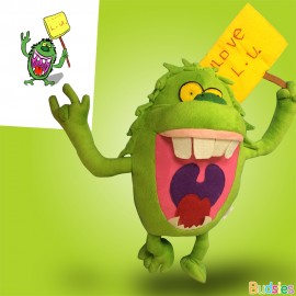 green stuffed animal monster with yellow sign