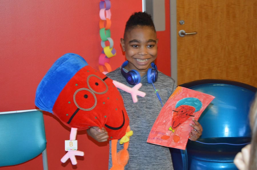 kid with their custom stuffed animal drawing